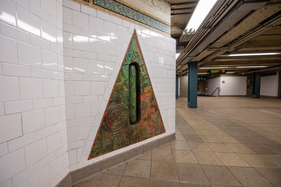 Station artwork featuring a large triangle with holes in the center.